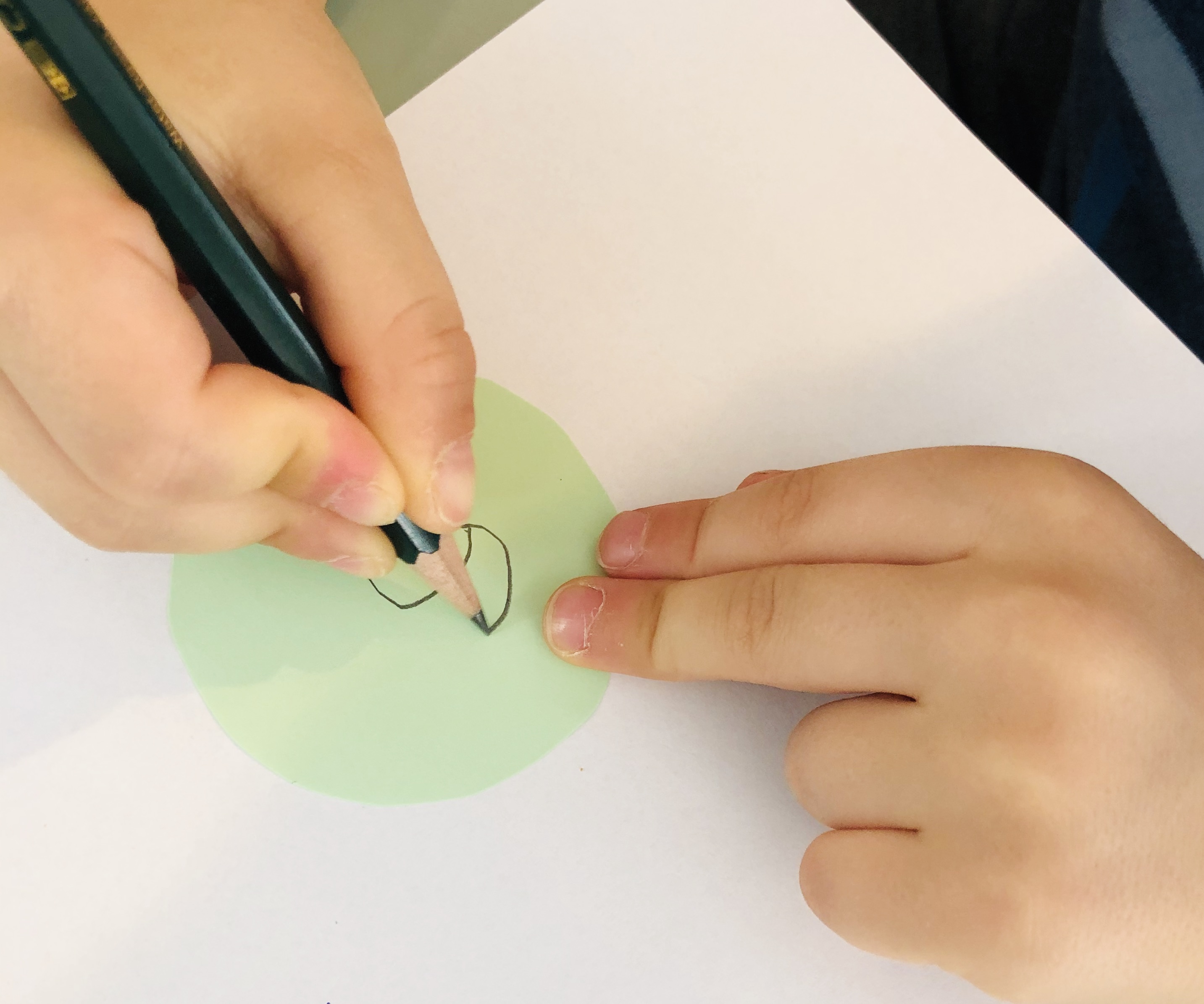 kid writing numbers for the numbers maze