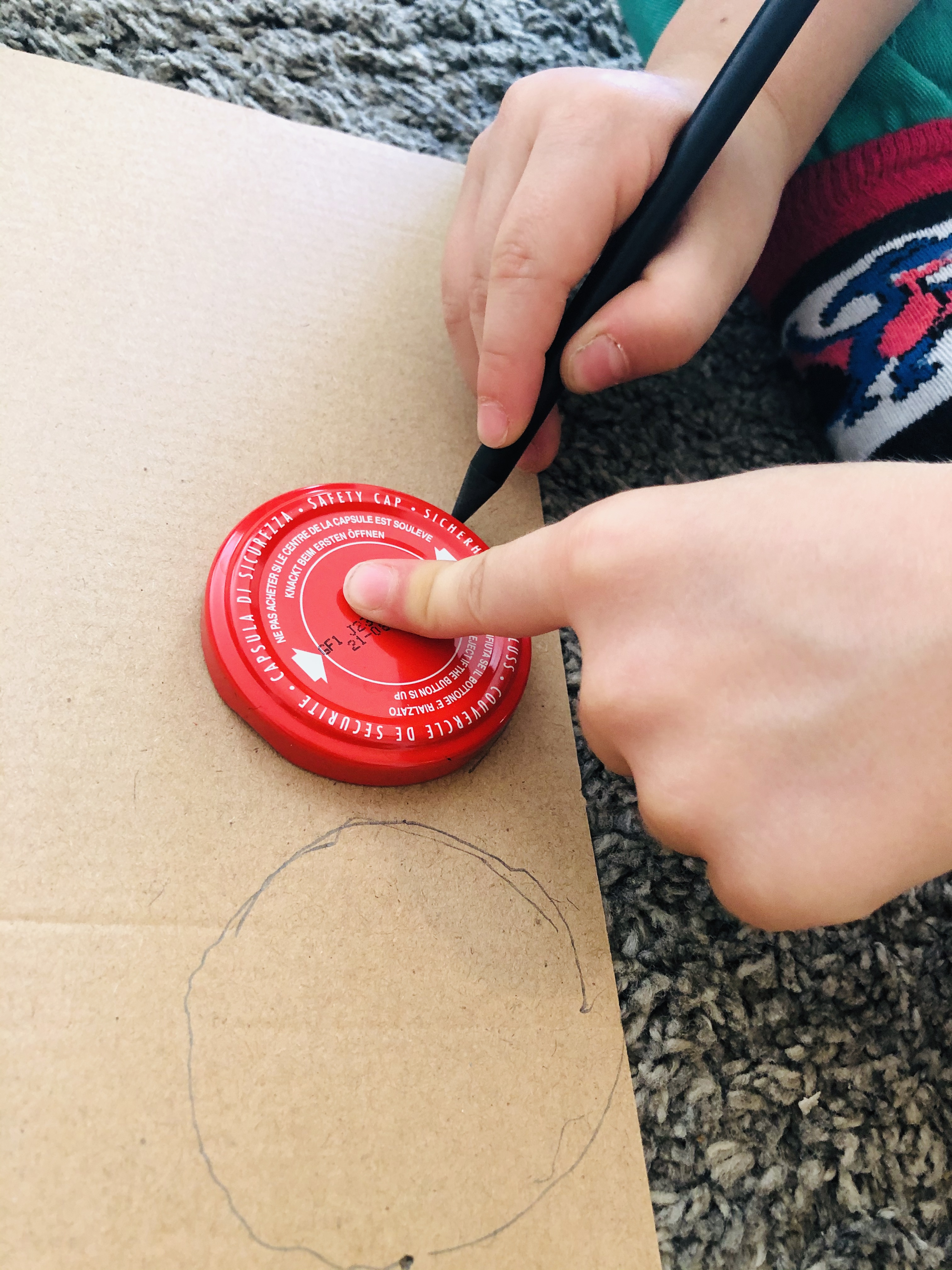 kid drawing a circle for a maze labyrinth