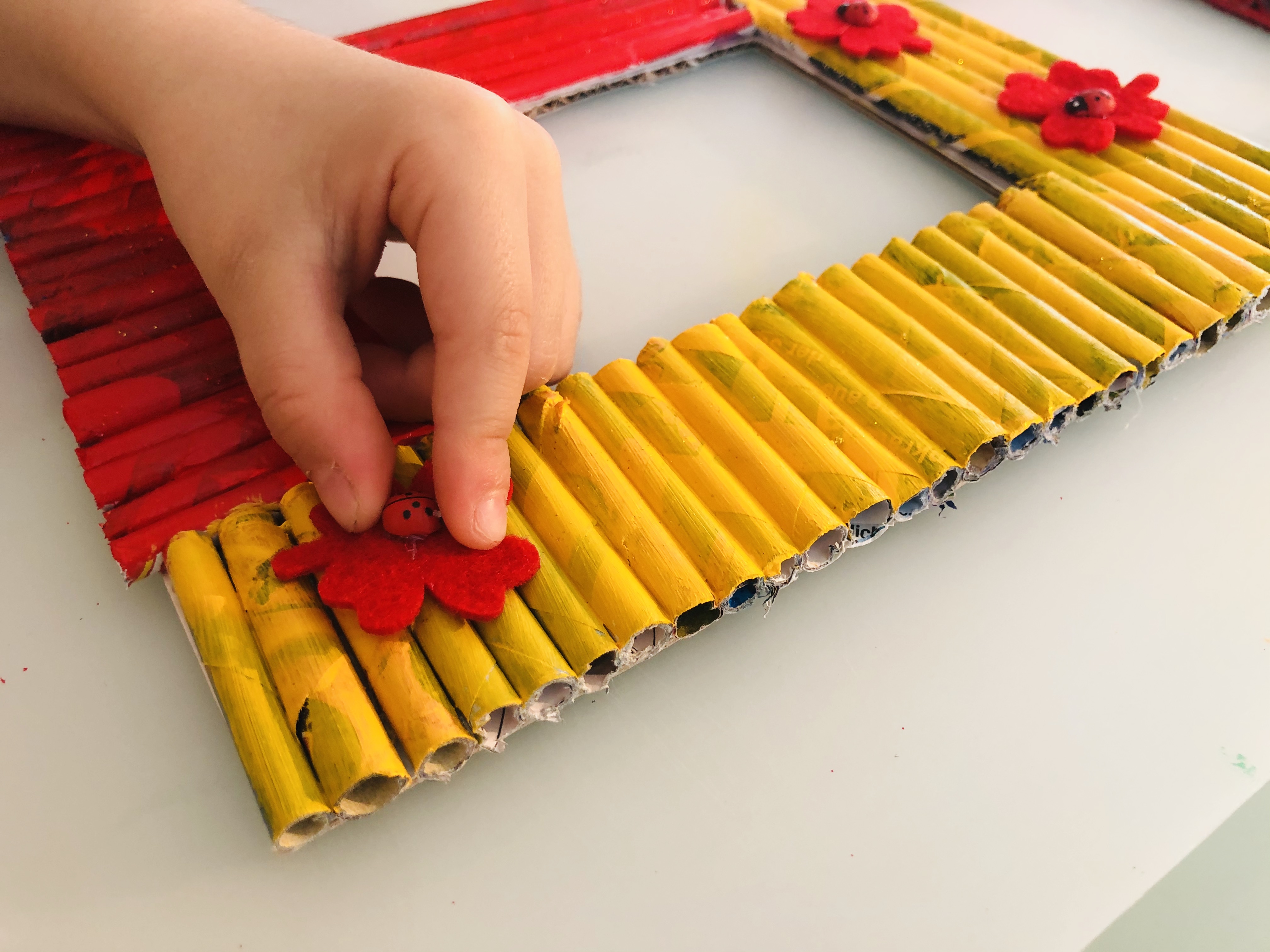 kid putting embellishments on the picture frame