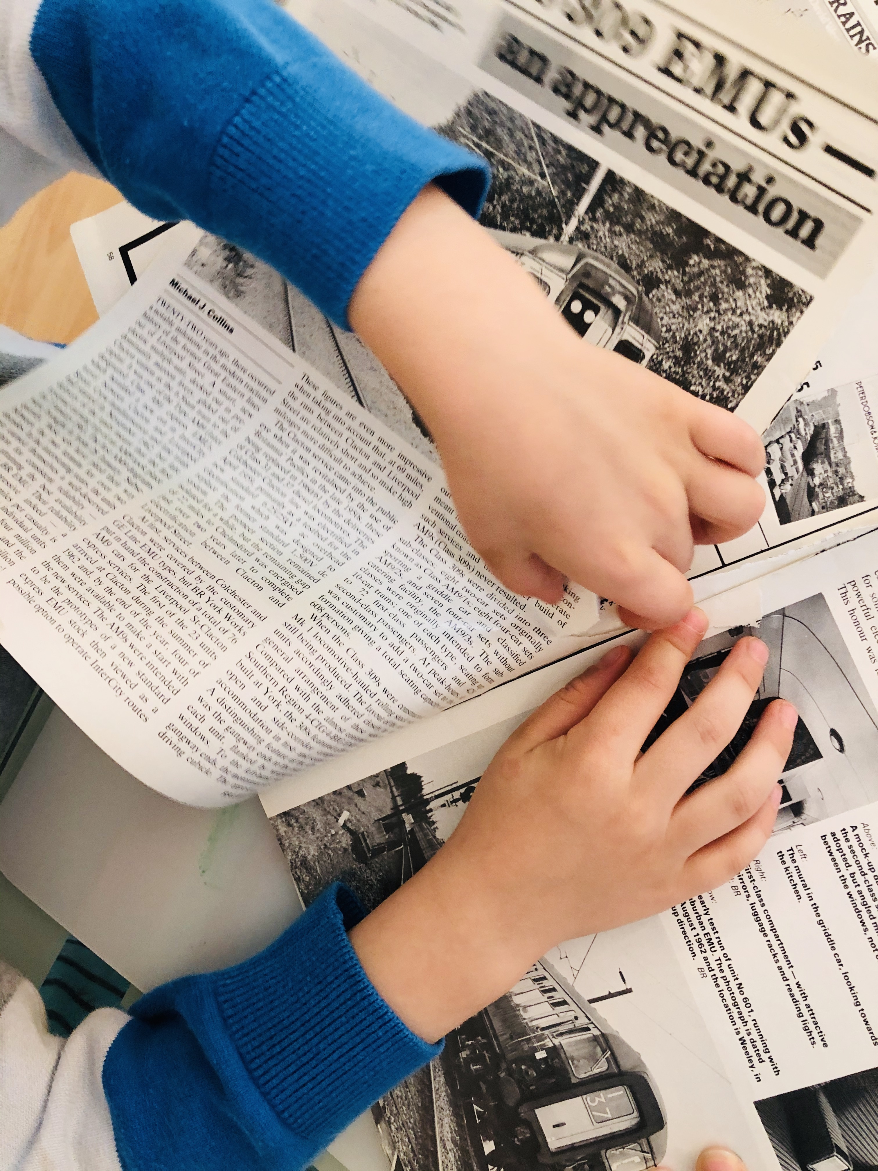 kid ripping pages out of an old magazine