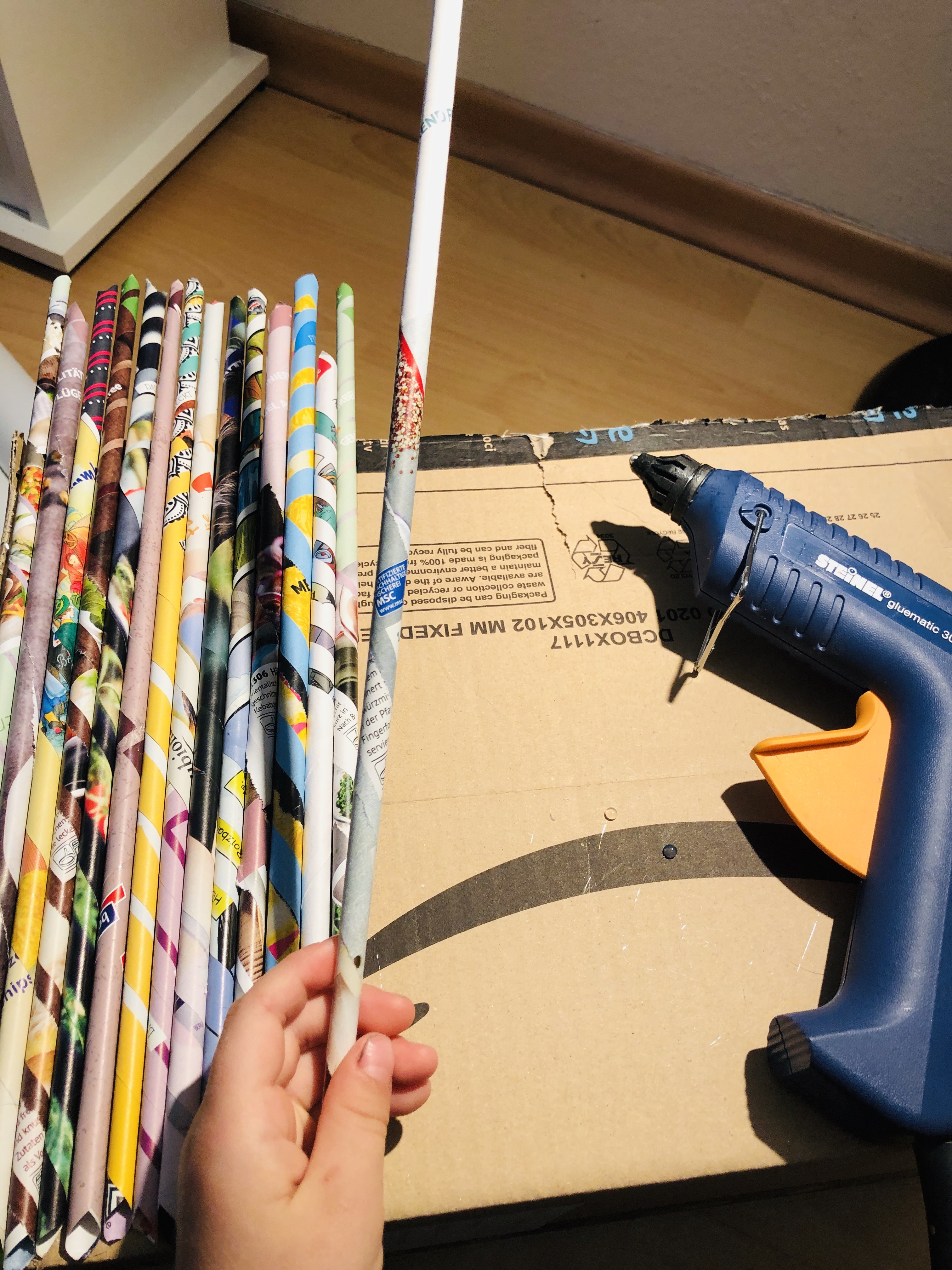 glueing paper rolls on a cardboard box