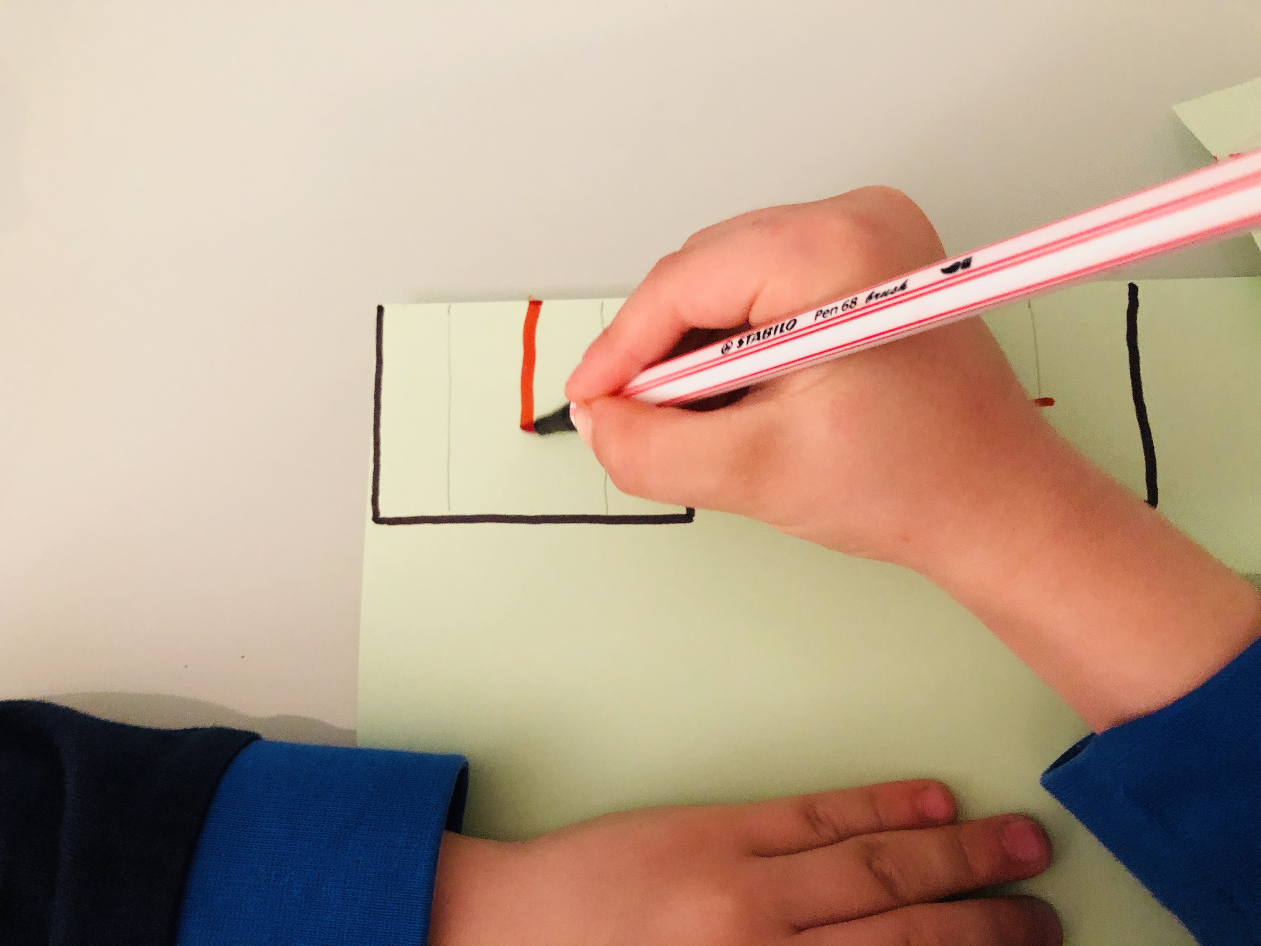 kid drawing windows for an upcycling projects city