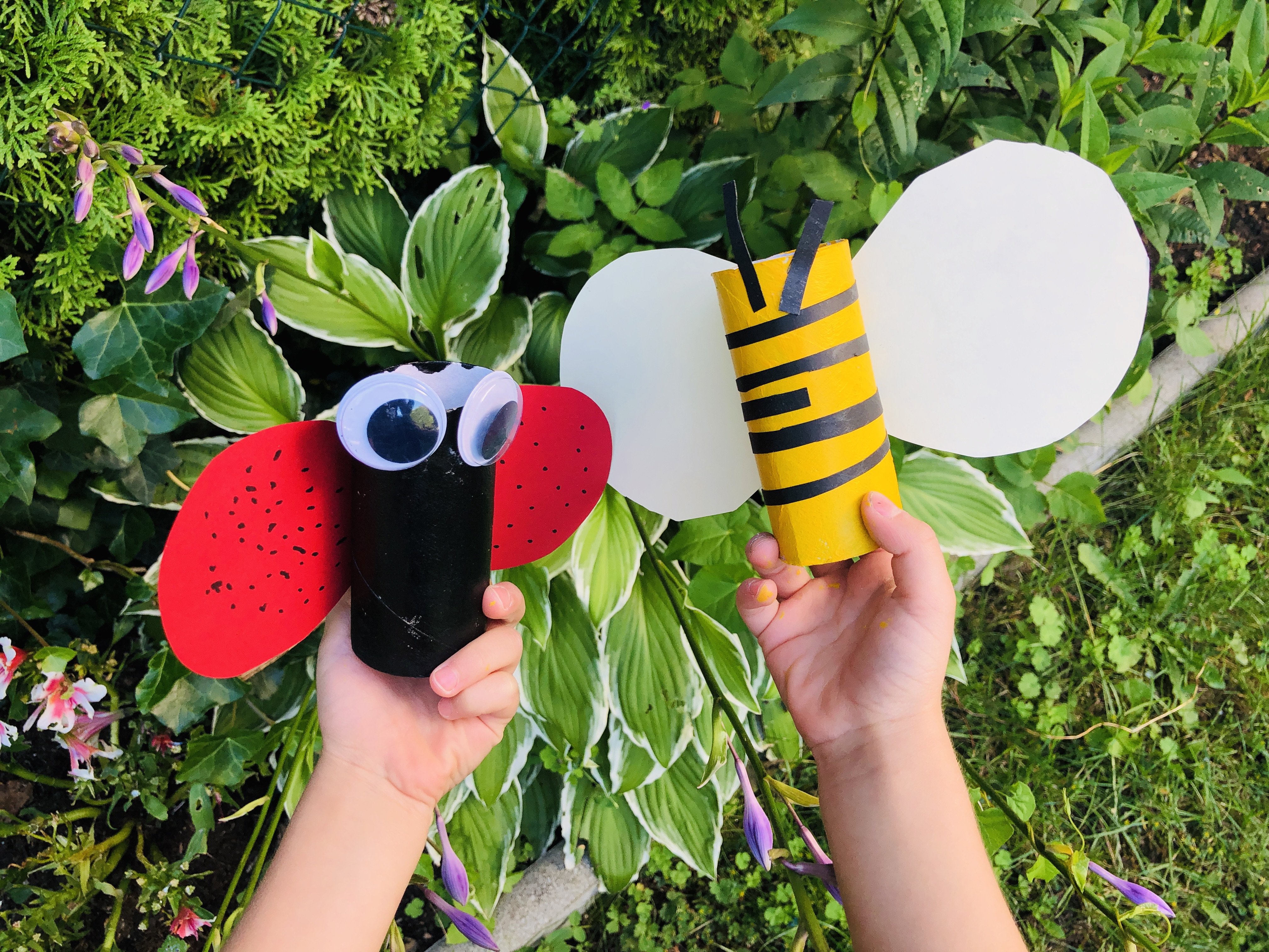 kid holding paper roll bee and ladybug