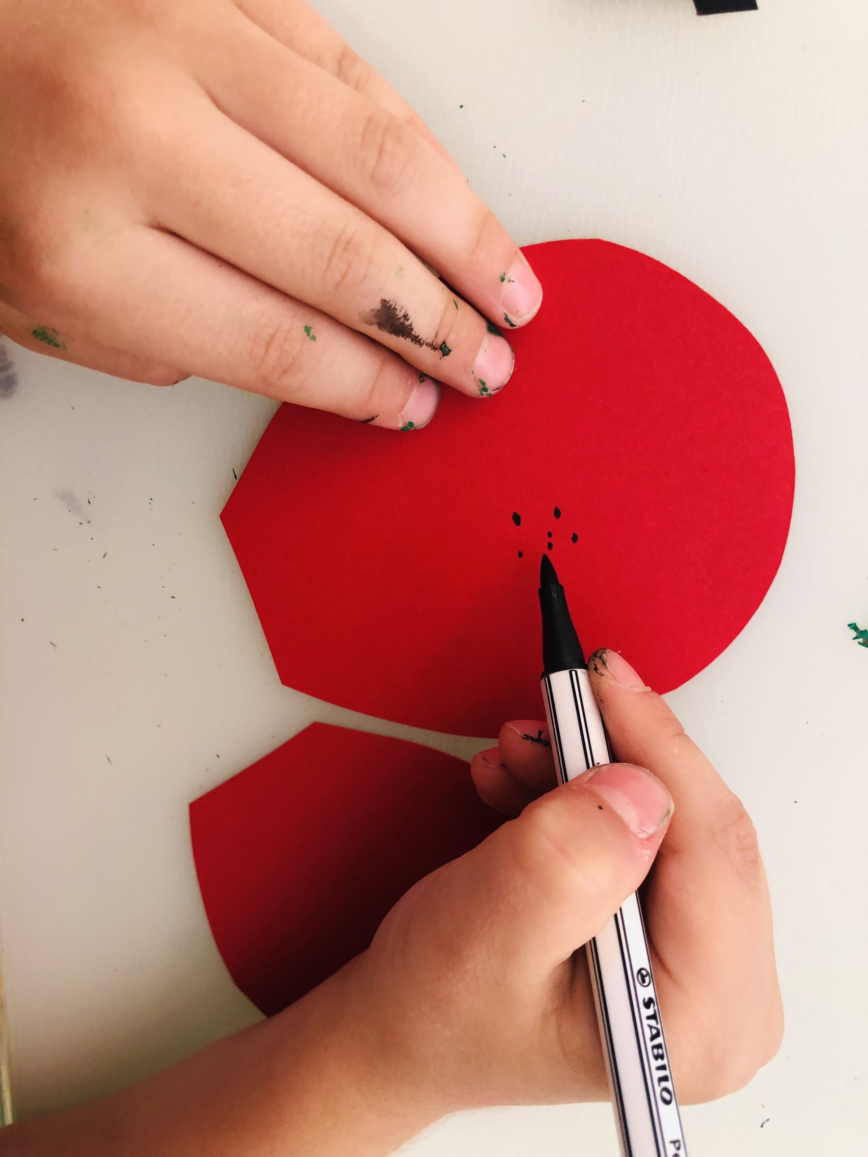 painting dots on ladybug's wings