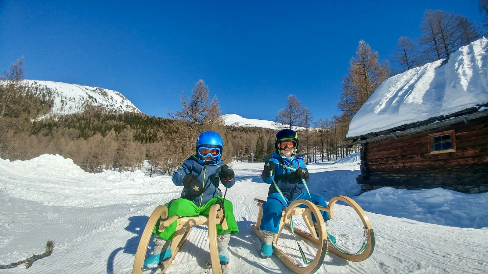 two kids on a sledge