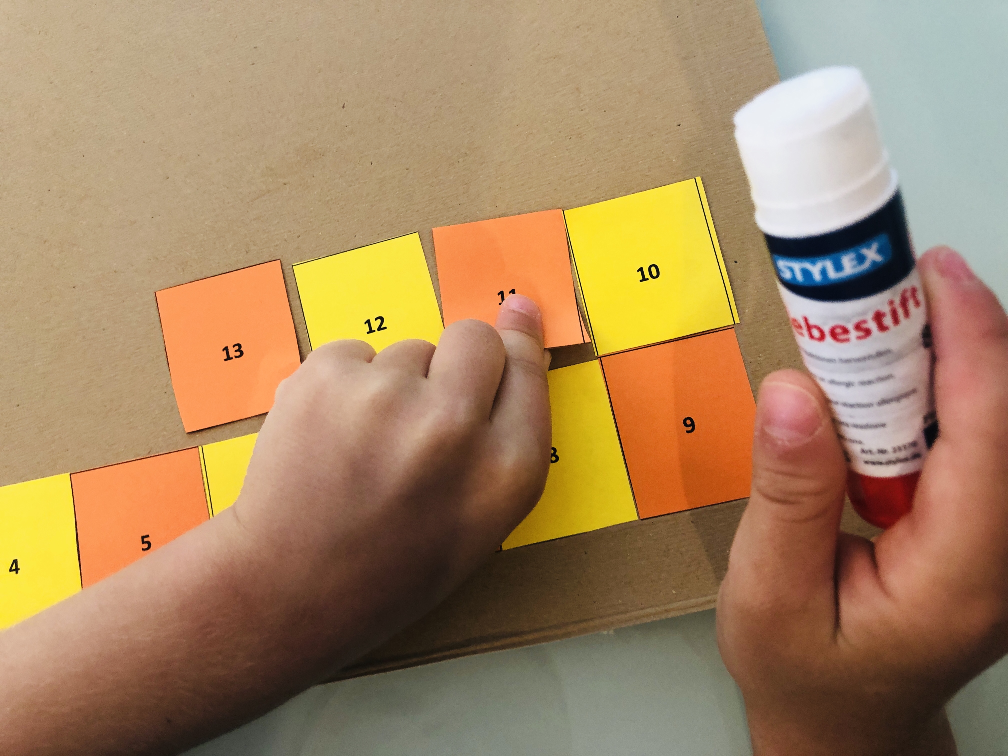 glueing the numbers for snakes and ladders game