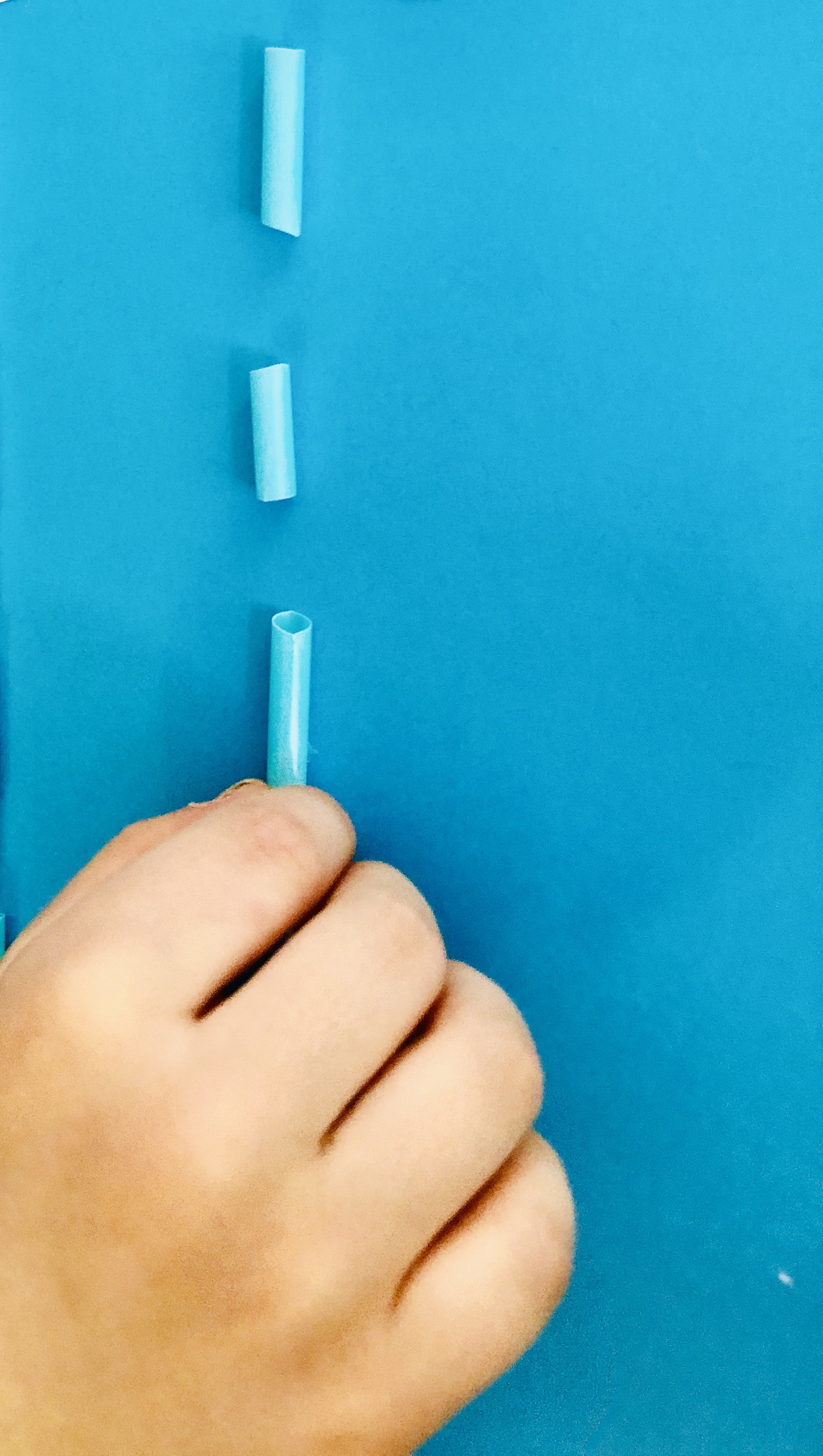 glueing pieces of straws for the rainy clouds