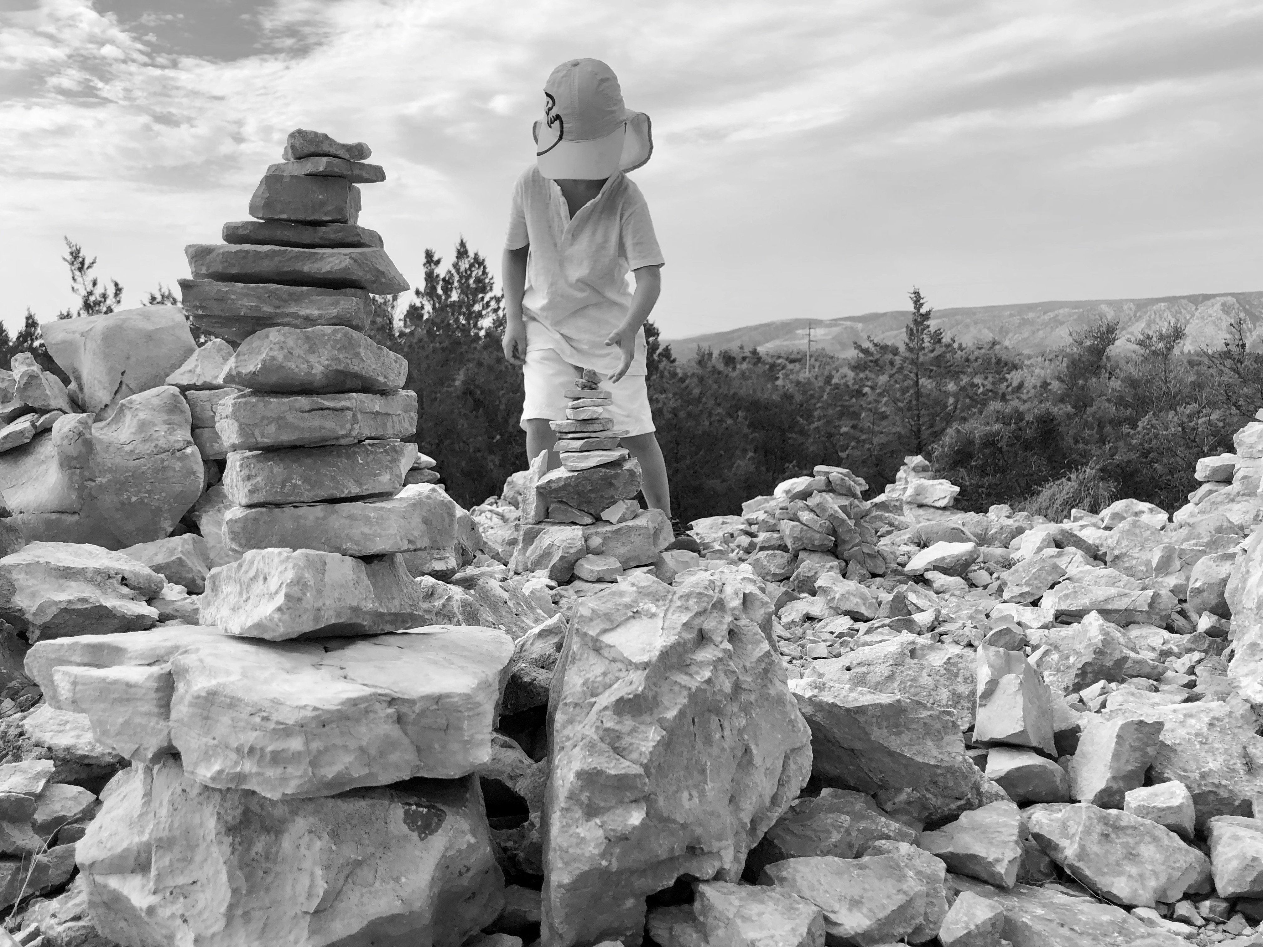 kid playing with stones pretending to be a spaceship captain 