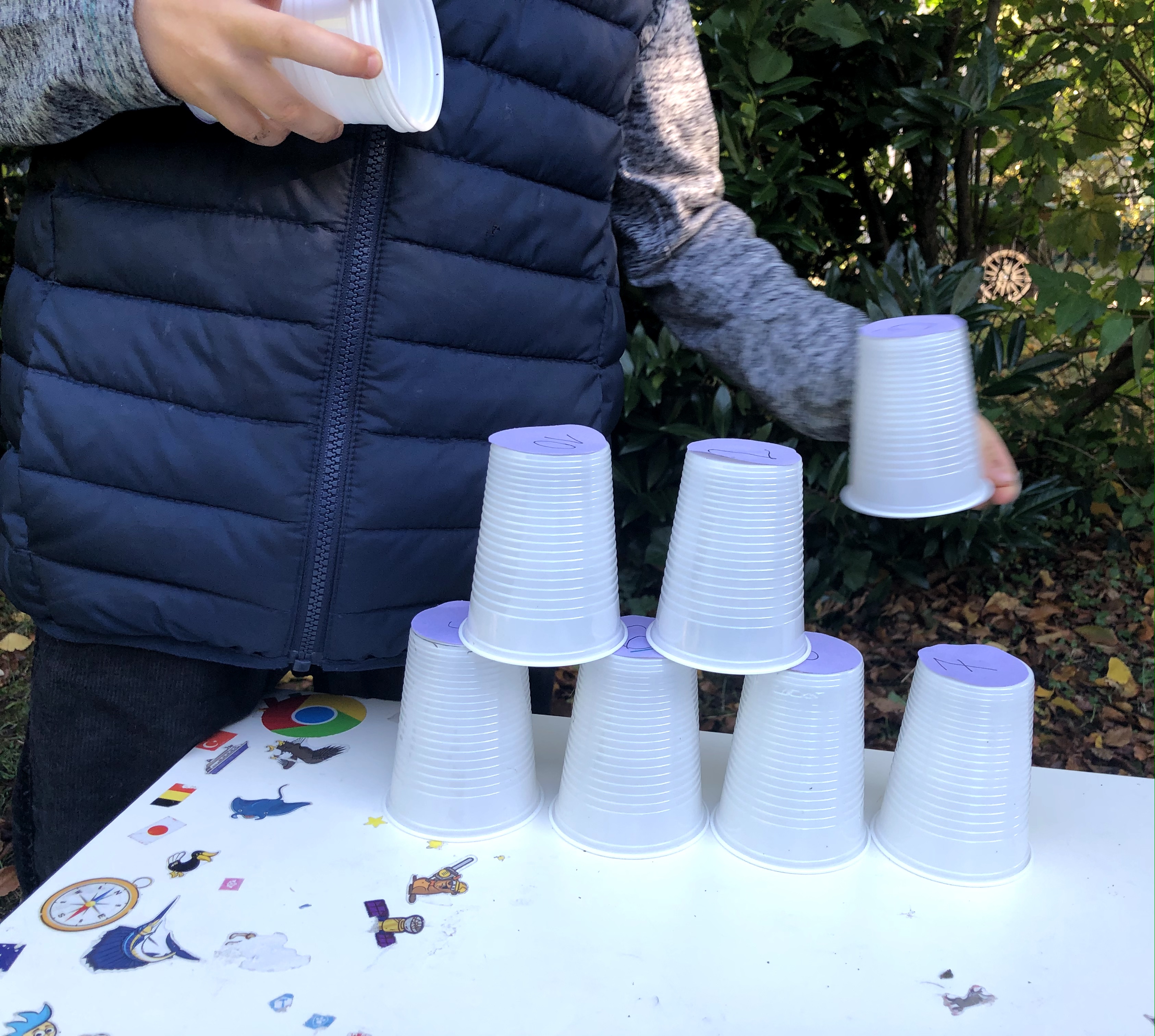 stacking plastic cups into a triangle