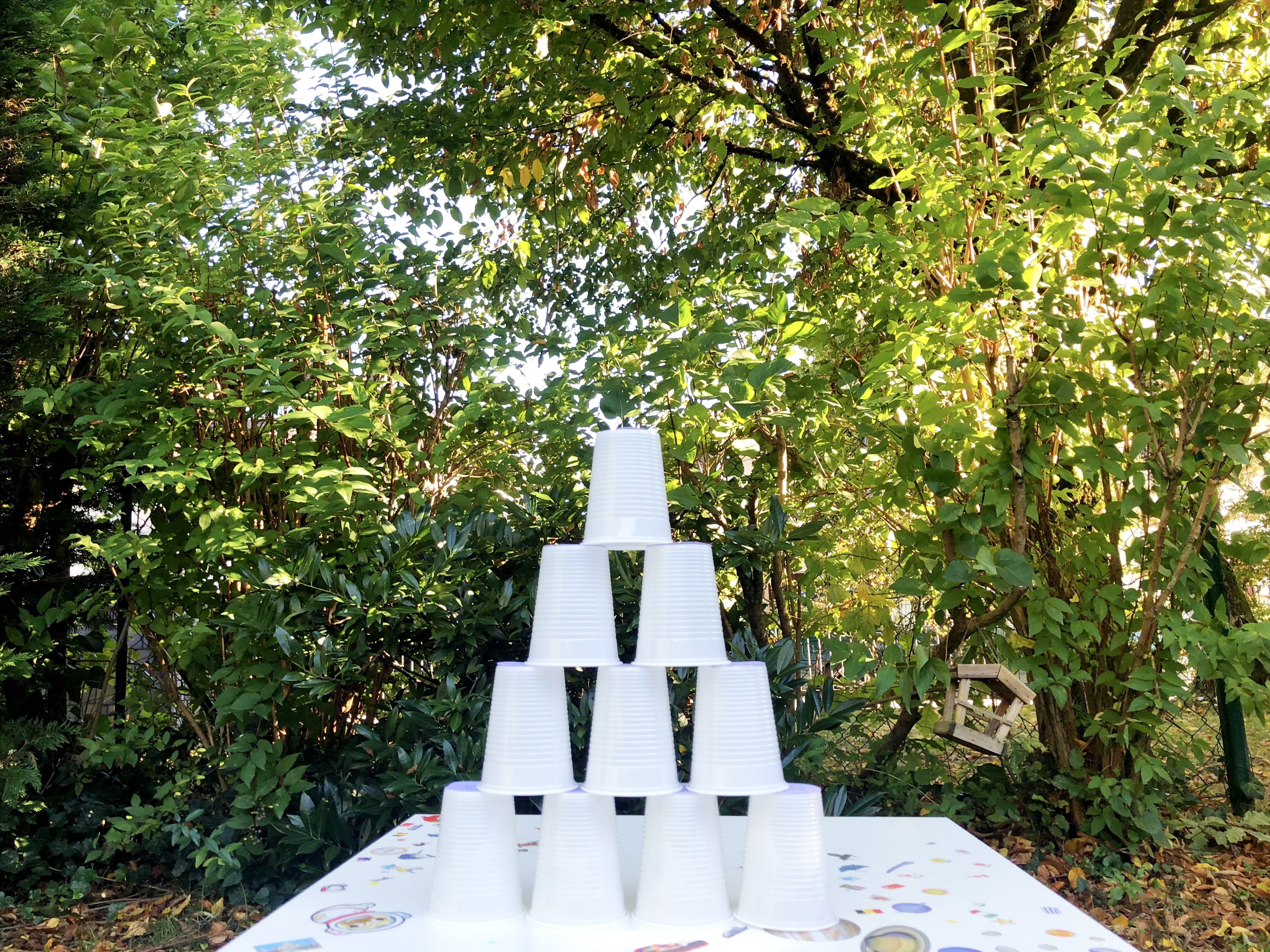 plastic cups stacked into a triangle 