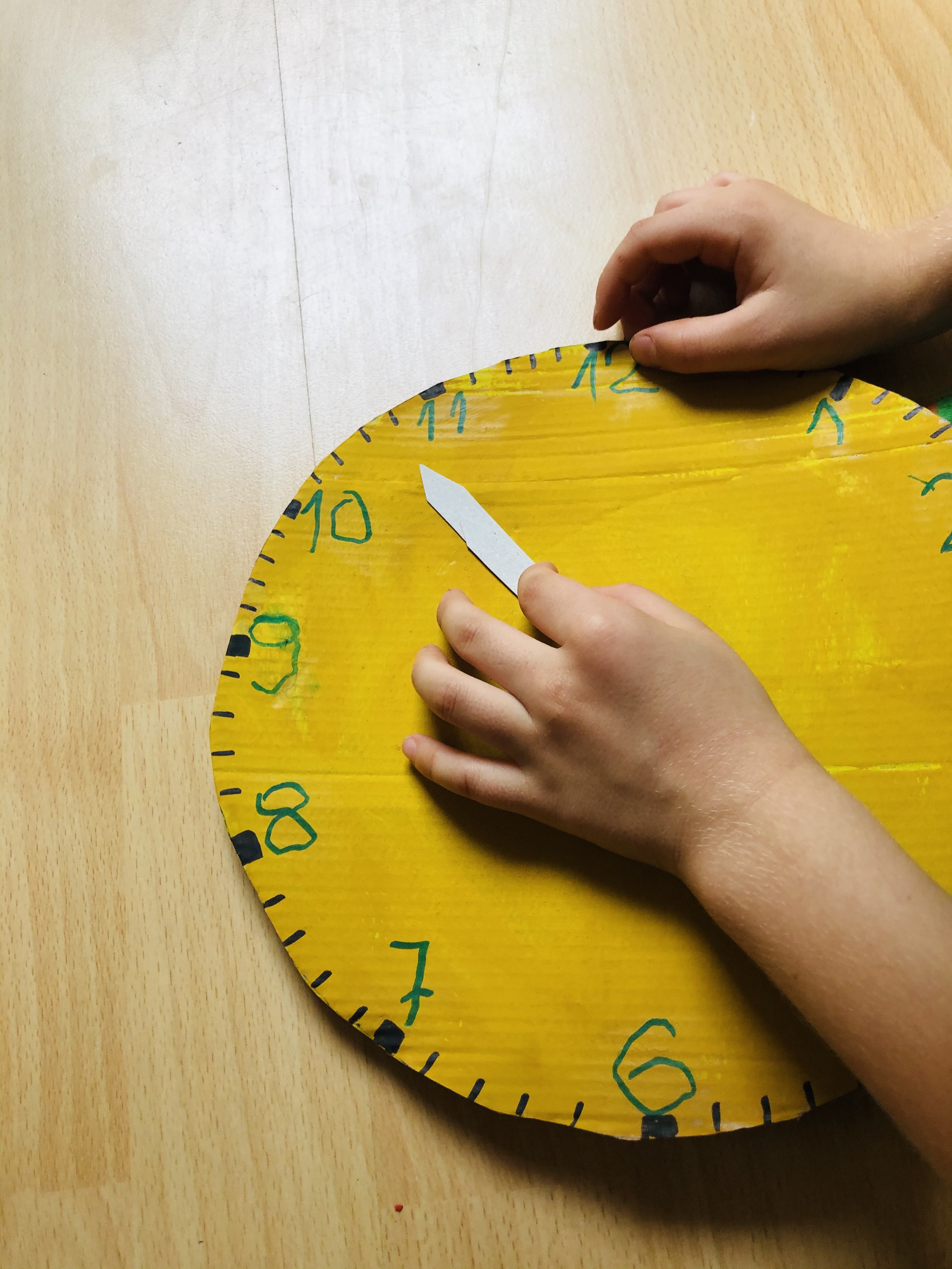 kid playing with a model clock