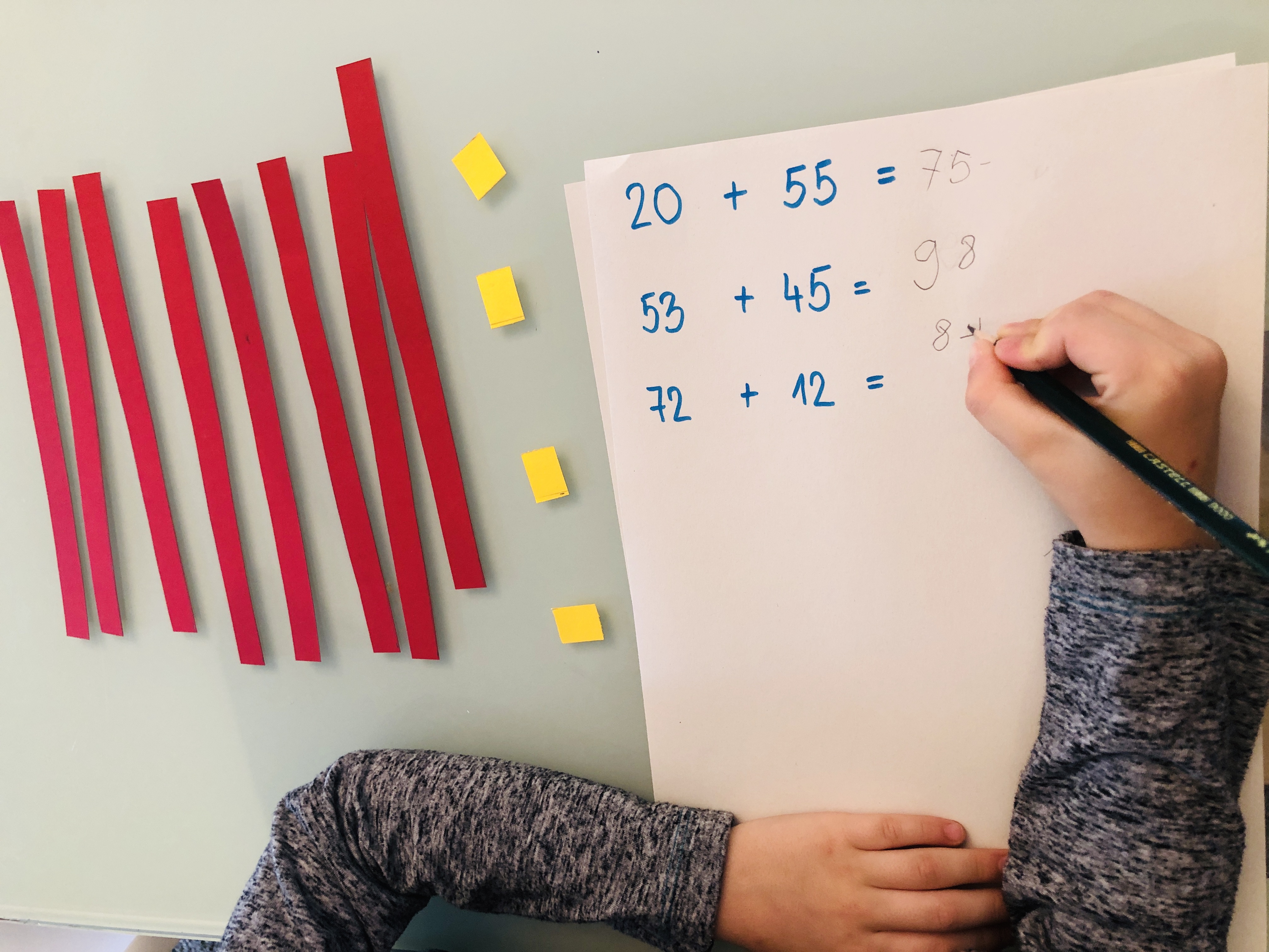 kid doing additions with two-digit numbers