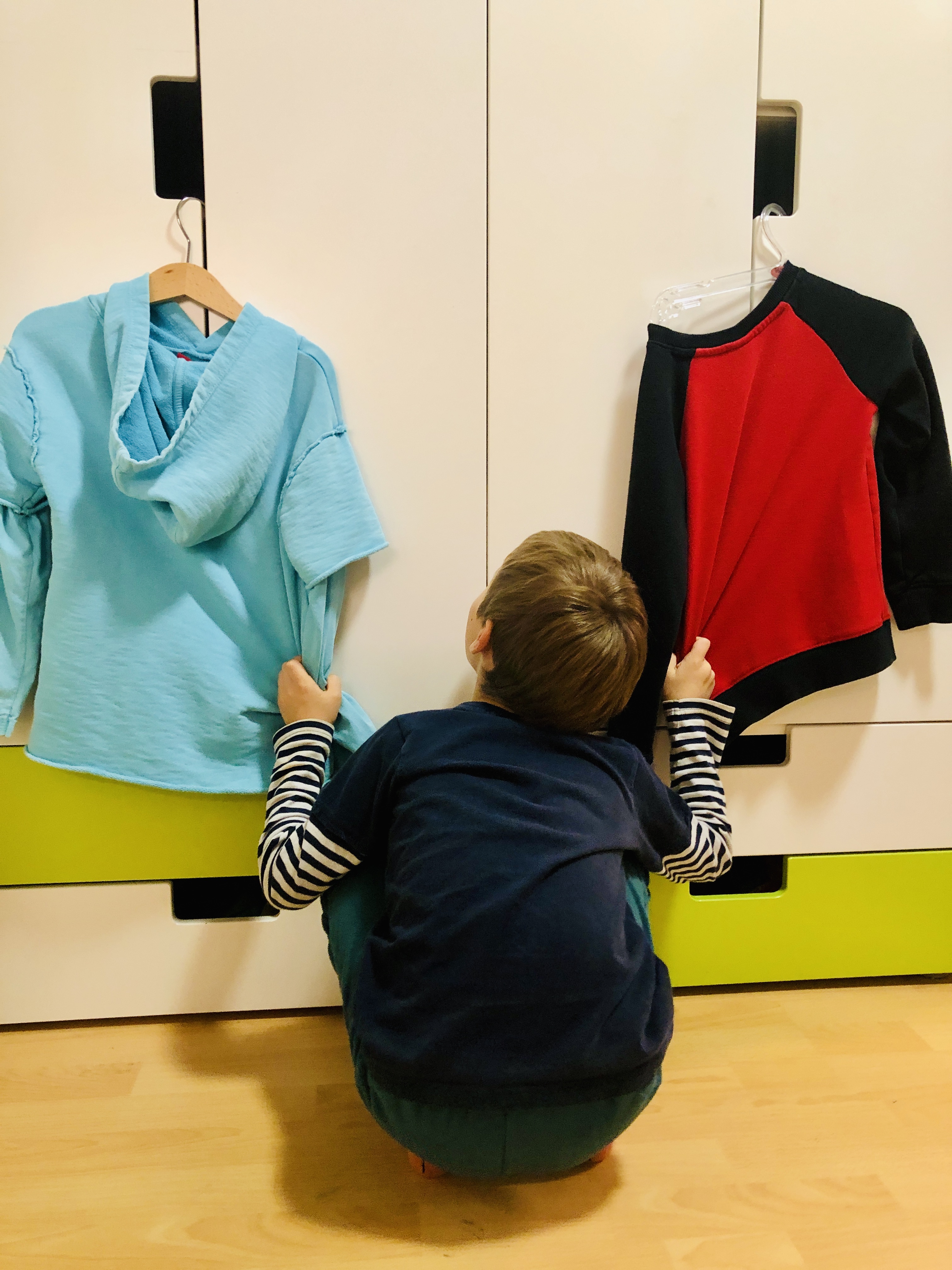 kid deciding which t-shirt to wear