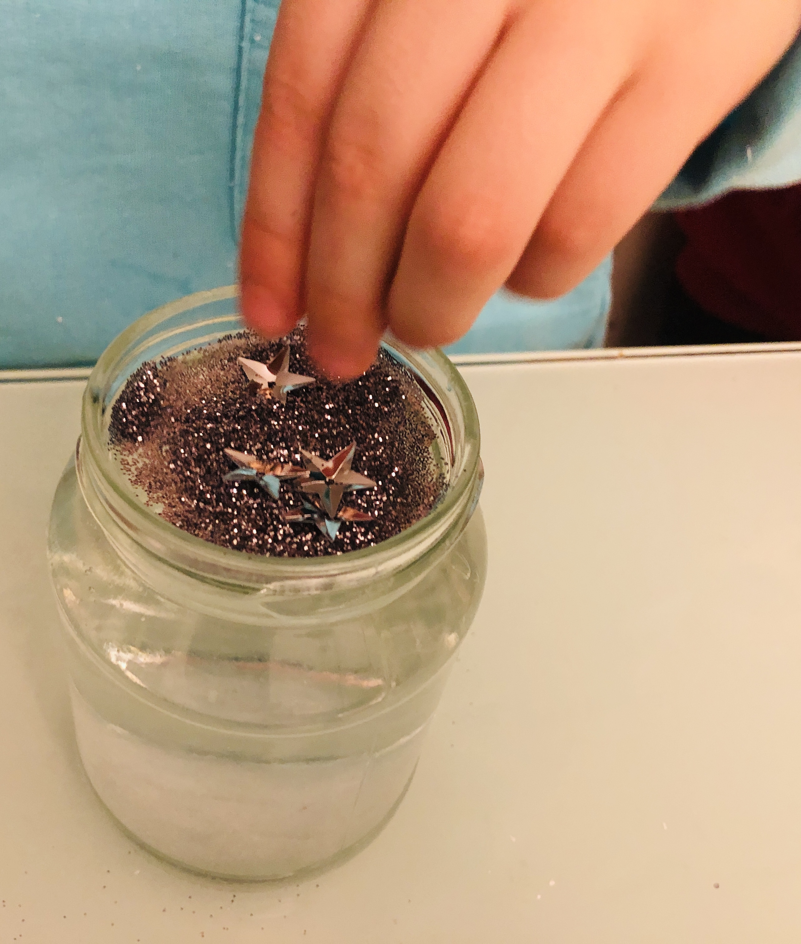 putting glitter in the jar