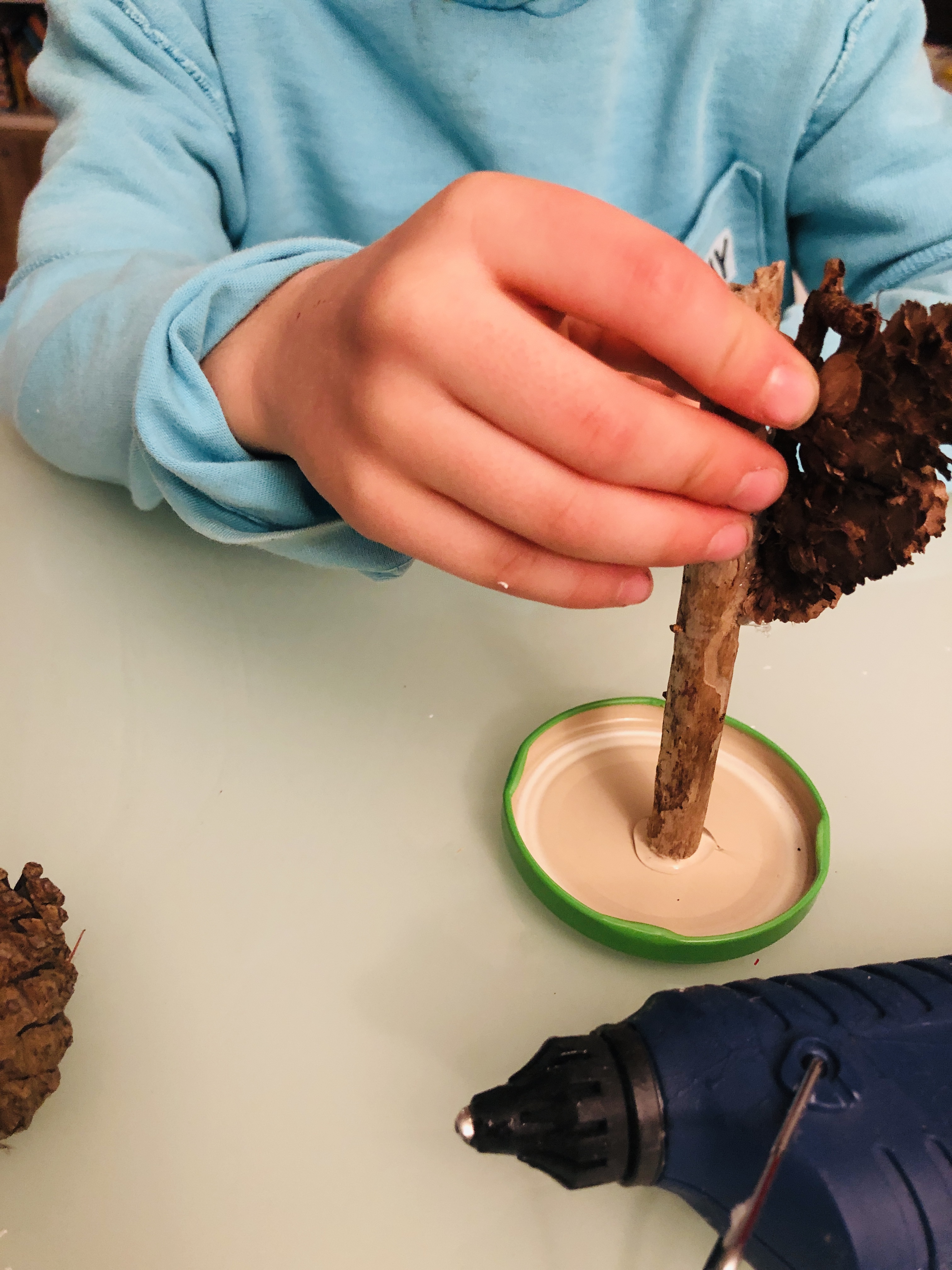 glueing the pine cones on the lid