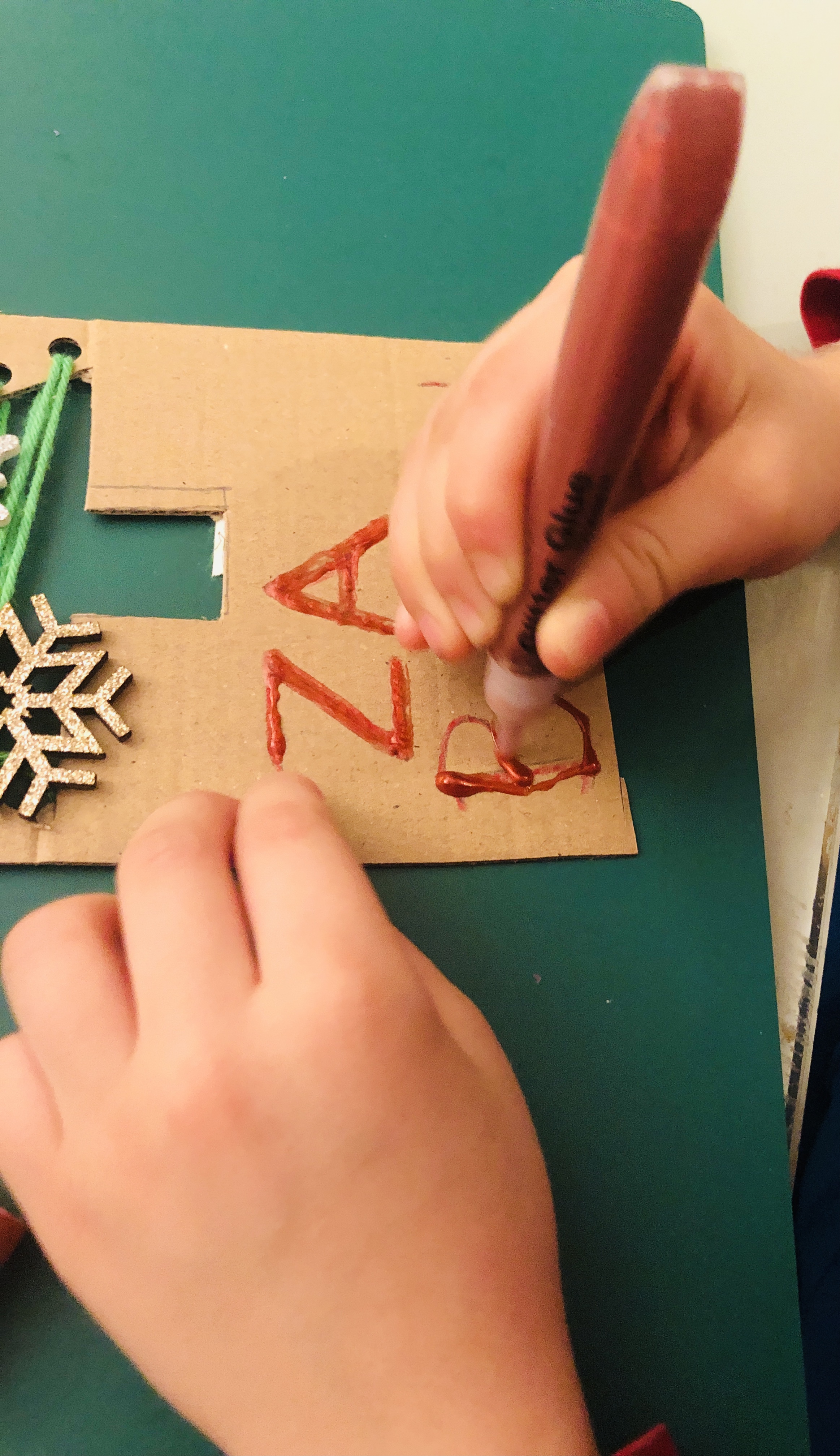 writing a note on a cardboard christmas tree